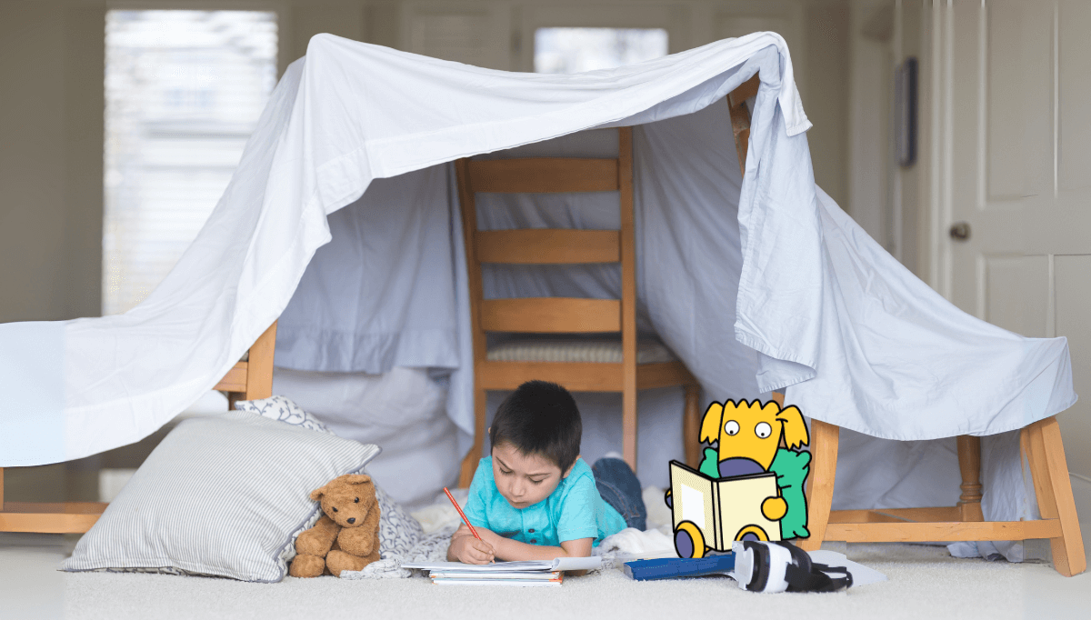 Child building a den indoors with blankets and cushions – creative rainy day summer activity