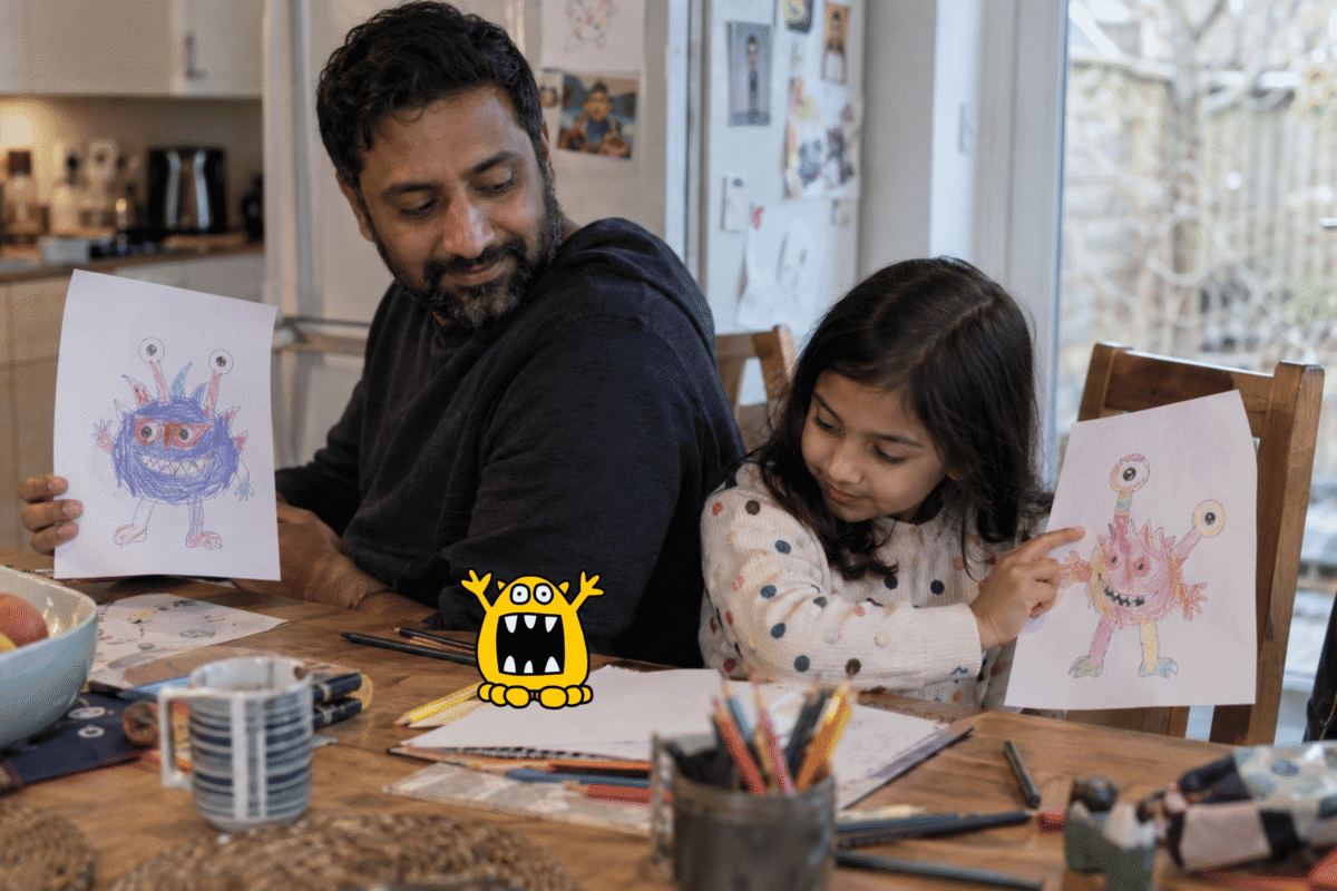 Father and daughter following step-by-step instructions to draw mystery monsters in an unplugged coding activity.